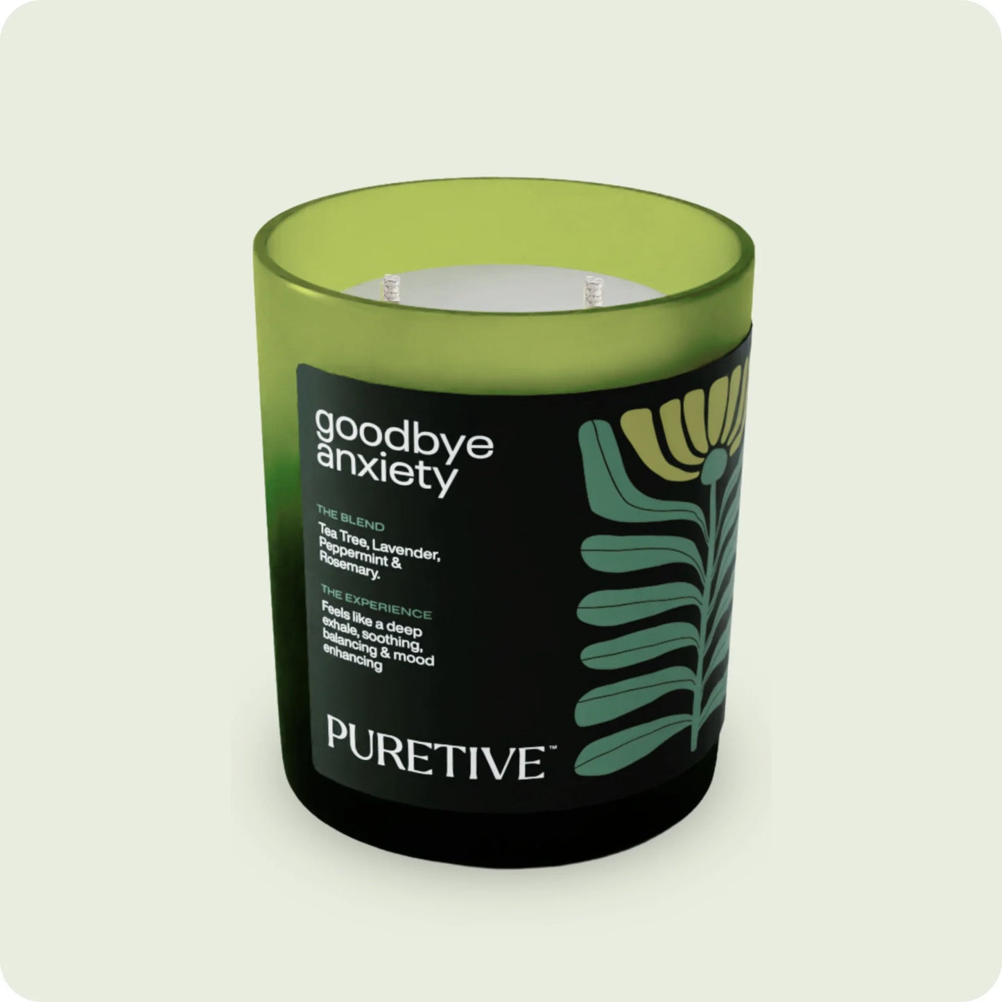 Scented candle labeled "goodbye anxiety" from PURETIVE with a green and black design.