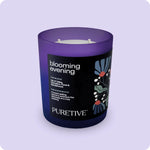 A purple scented candle with two wicks, labeled 