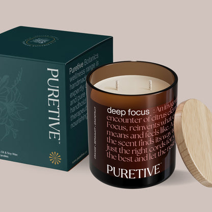 Scented candle with lid off beside its teal packaging box labeled "PURETIVE".