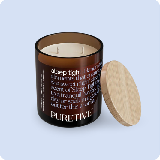 Aromatic candle with two wicks in a brown glass jar beside a wooden lid, labeled 'PURETIVE' for sleep enhancement.